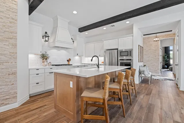 a kitchen with white cabinets and counter space