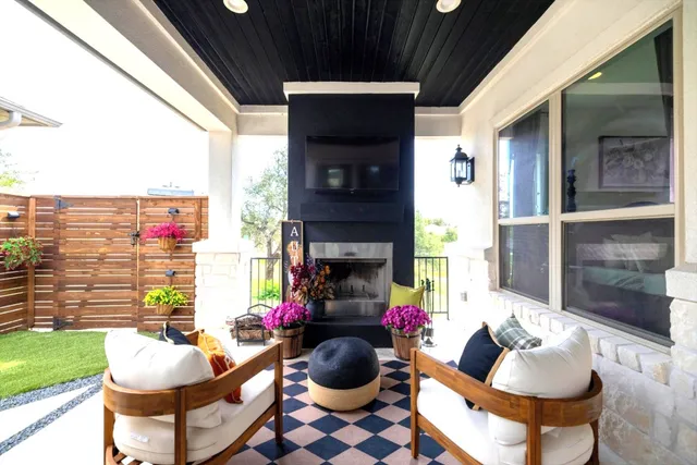 a living room with fireplace furniture and a floor to ceiling window
