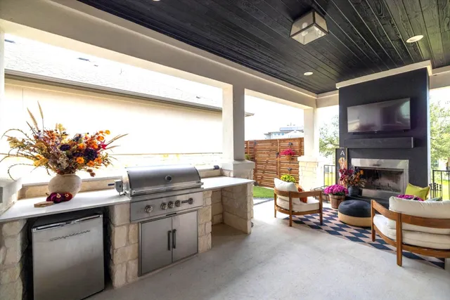a kitchen with furniture a flat screen tv and a fireplace