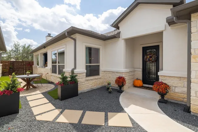 a view of a house with backyard and sitting area