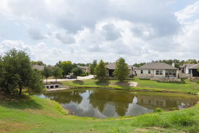 a view of a lake with a house in the background