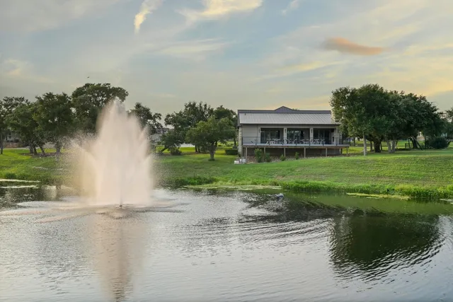 a view of a lake with a house in the background