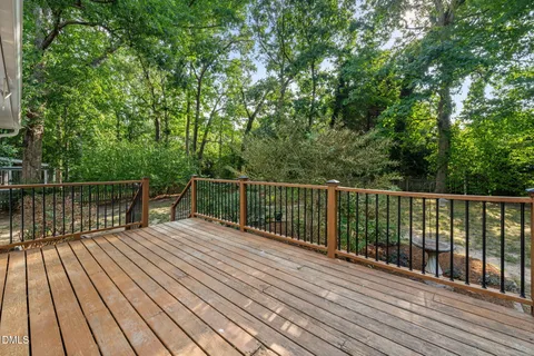 a view of backyard with deck and wooden floor