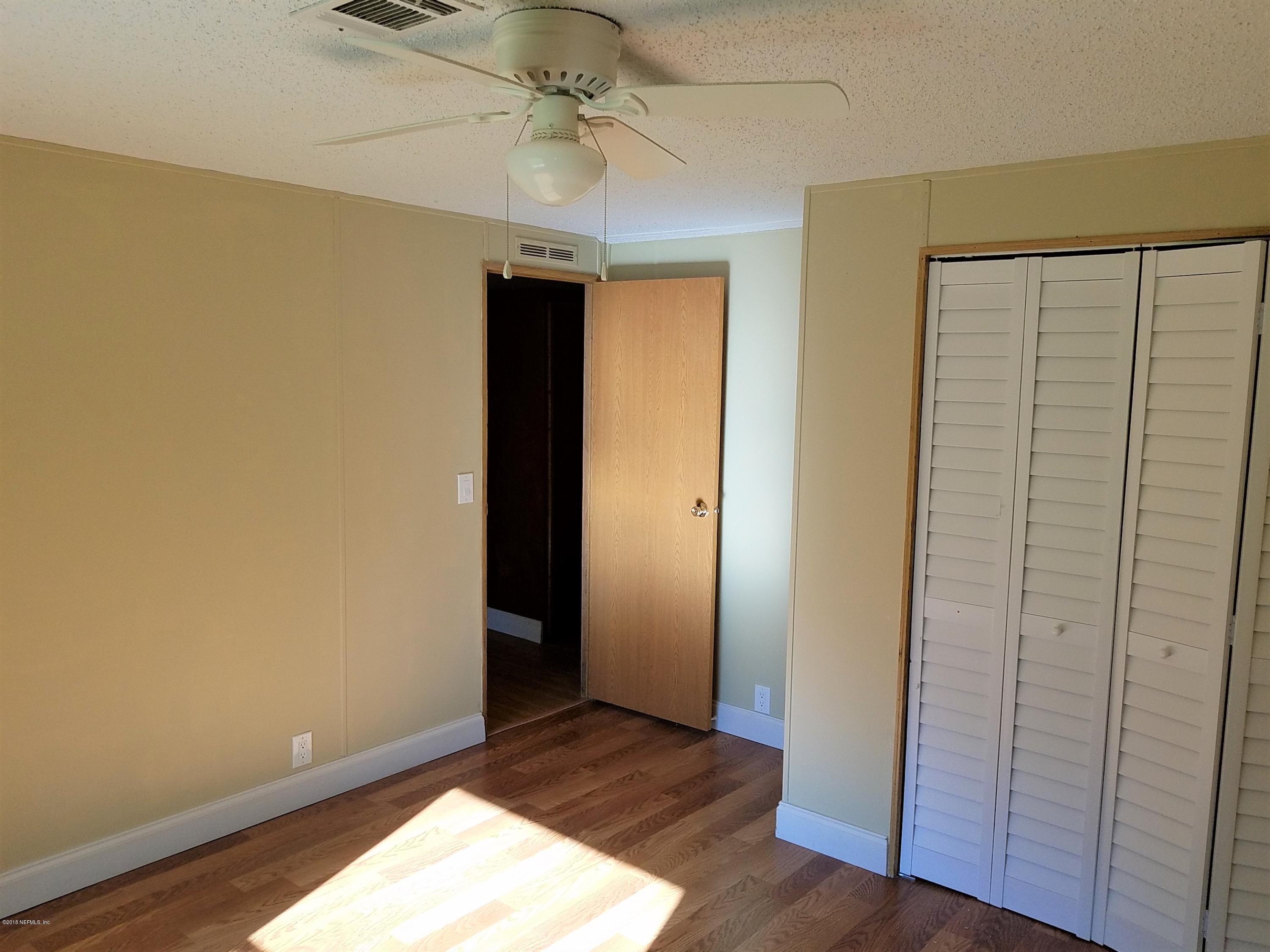 2801 Green Acres Road, Unit EXTENSION St. Augustine, FL 32084 - Photo 12 of 30 an empty room with wooden floor closet and windows