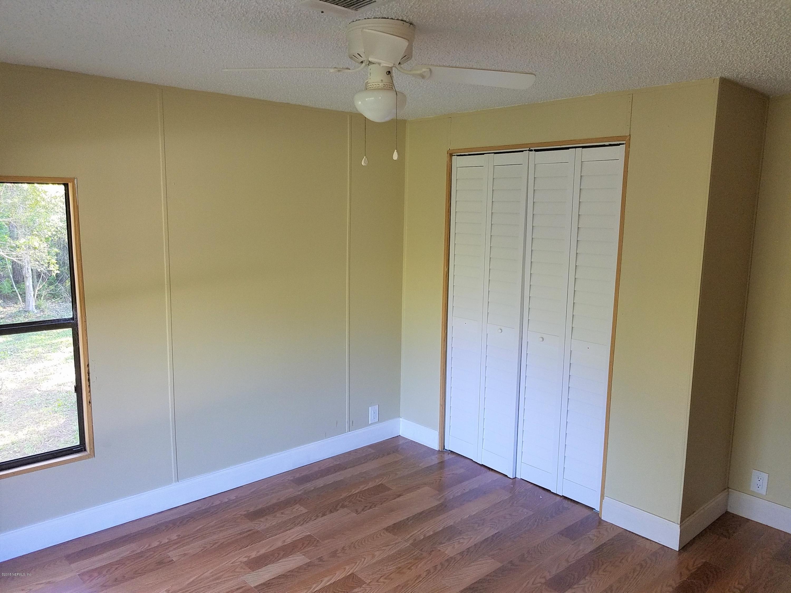 2801 Green Acres Road, Unit EXTENSION St. Augustine, FL 32084 - Photo 13 of 30 a view of empty room with wooden floor and fan