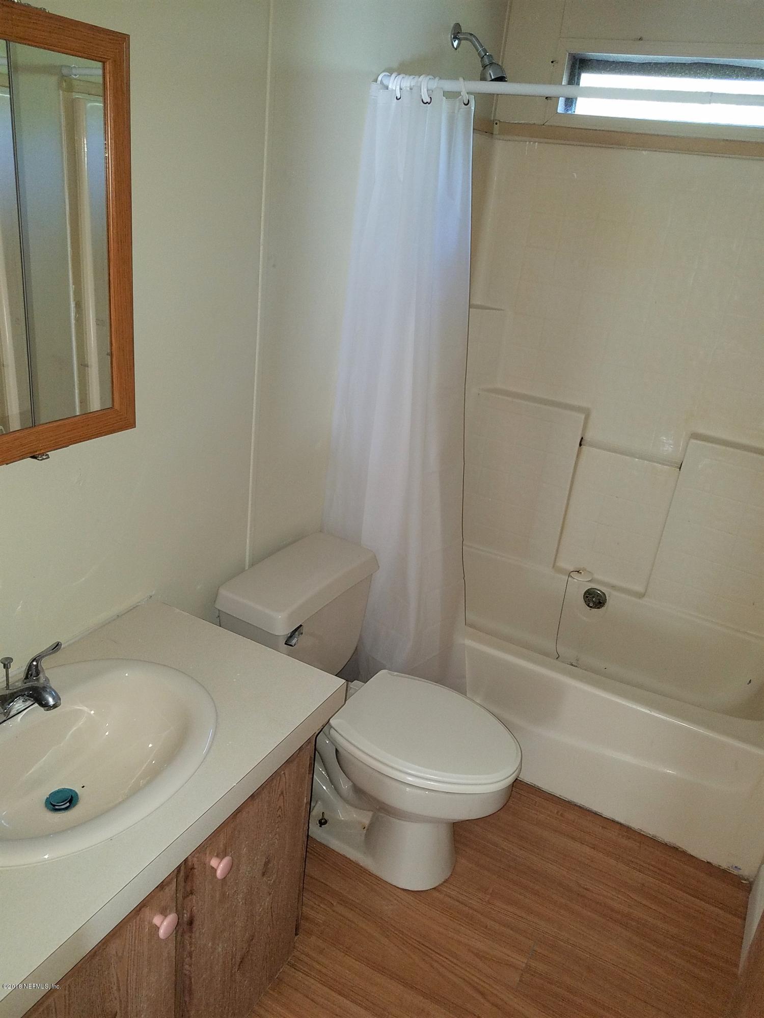 2801 Green Acres Road, Unit EXTENSION St. Augustine, FL 32084 - Photo 14 of 30 a bathroom with a sink a toilet and shower