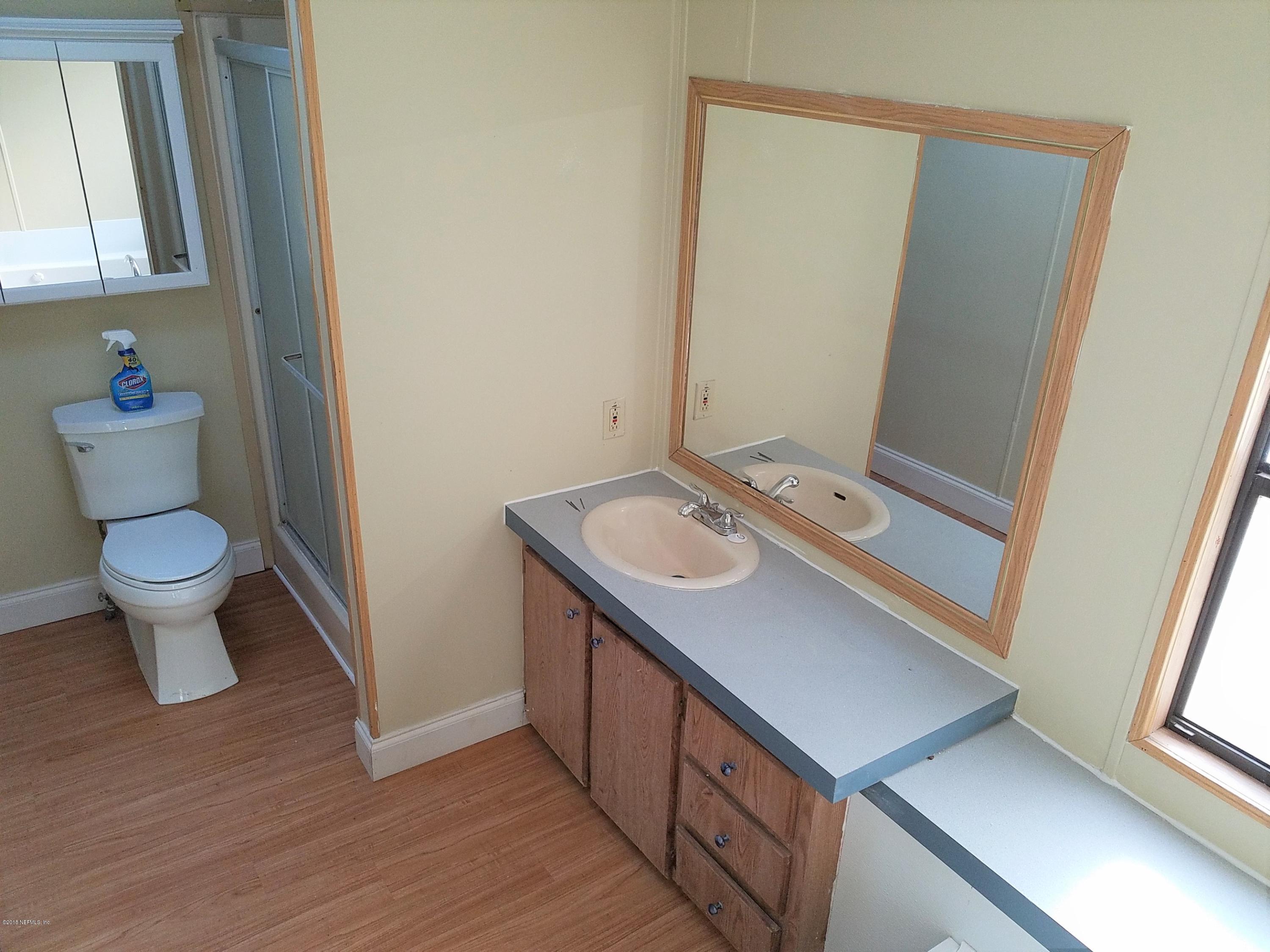 2801 Green Acres Road, Unit EXTENSION St. Augustine, FL 32084 - Photo 15 of 30 a bathroom with a sink a toilet and a mirror