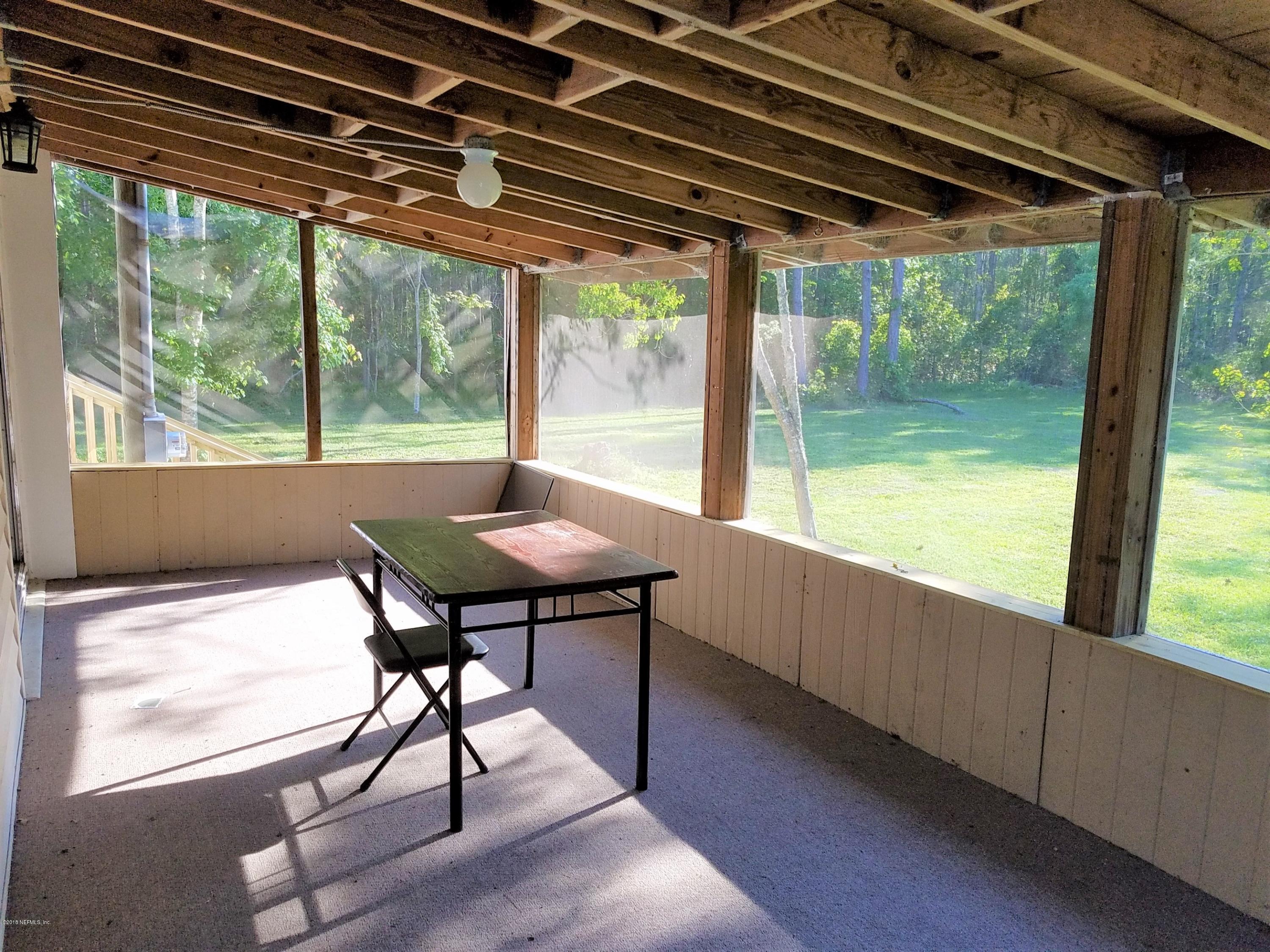 2801 Green Acres Road, Unit EXTENSION St. Augustine, FL 32084 - Photo 17 of 30 a view of a porch with furniture and wooden floor