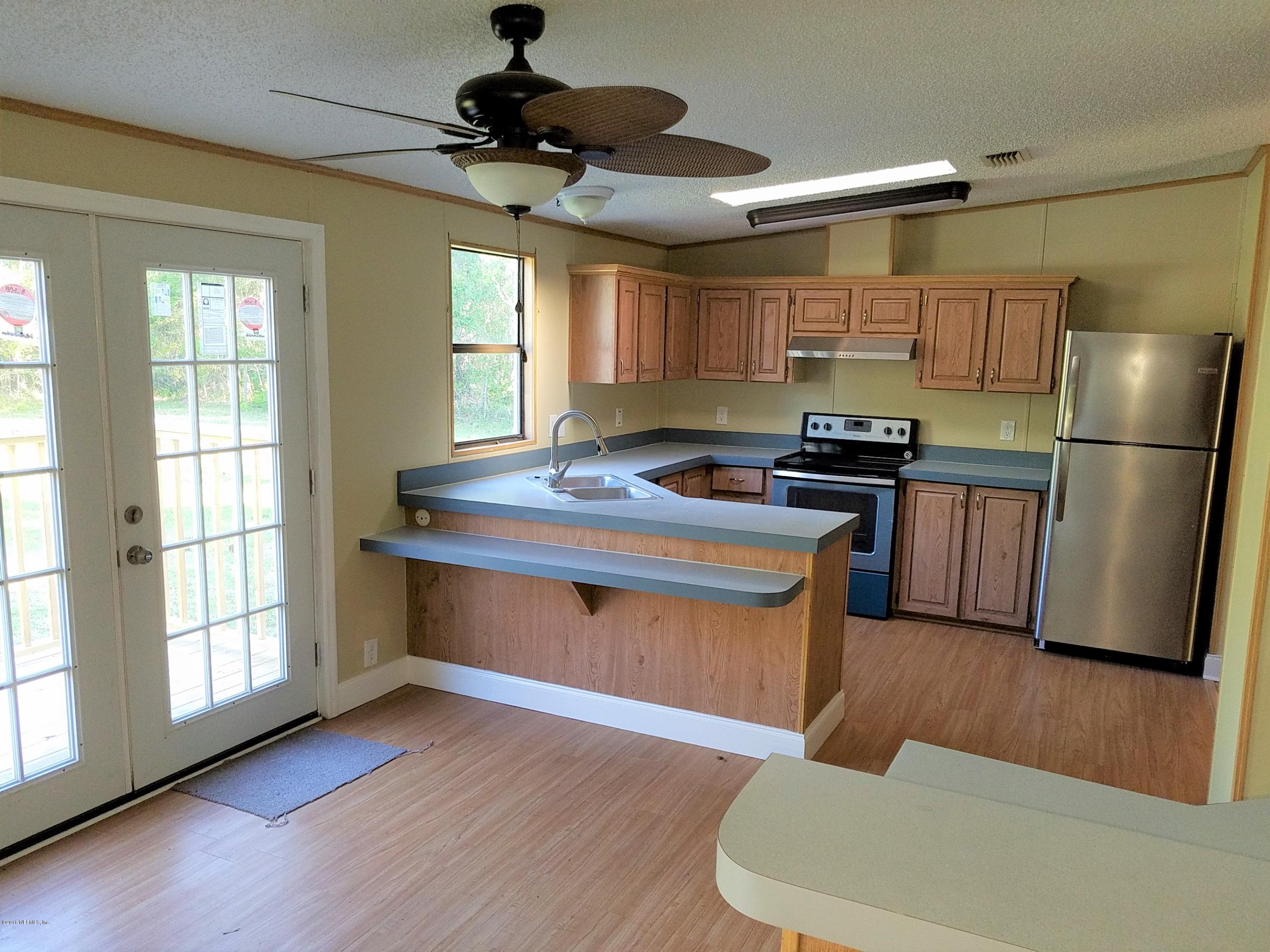 2801 Green Acres Road, Unit EXTENSION St. Augustine, FL 32084 - Photo 2 of 30 a kitchen with stainless steel appliances granite countertop a refrigerator a stove a sink dishwasher a microwave oven with cabinets and wooden floor