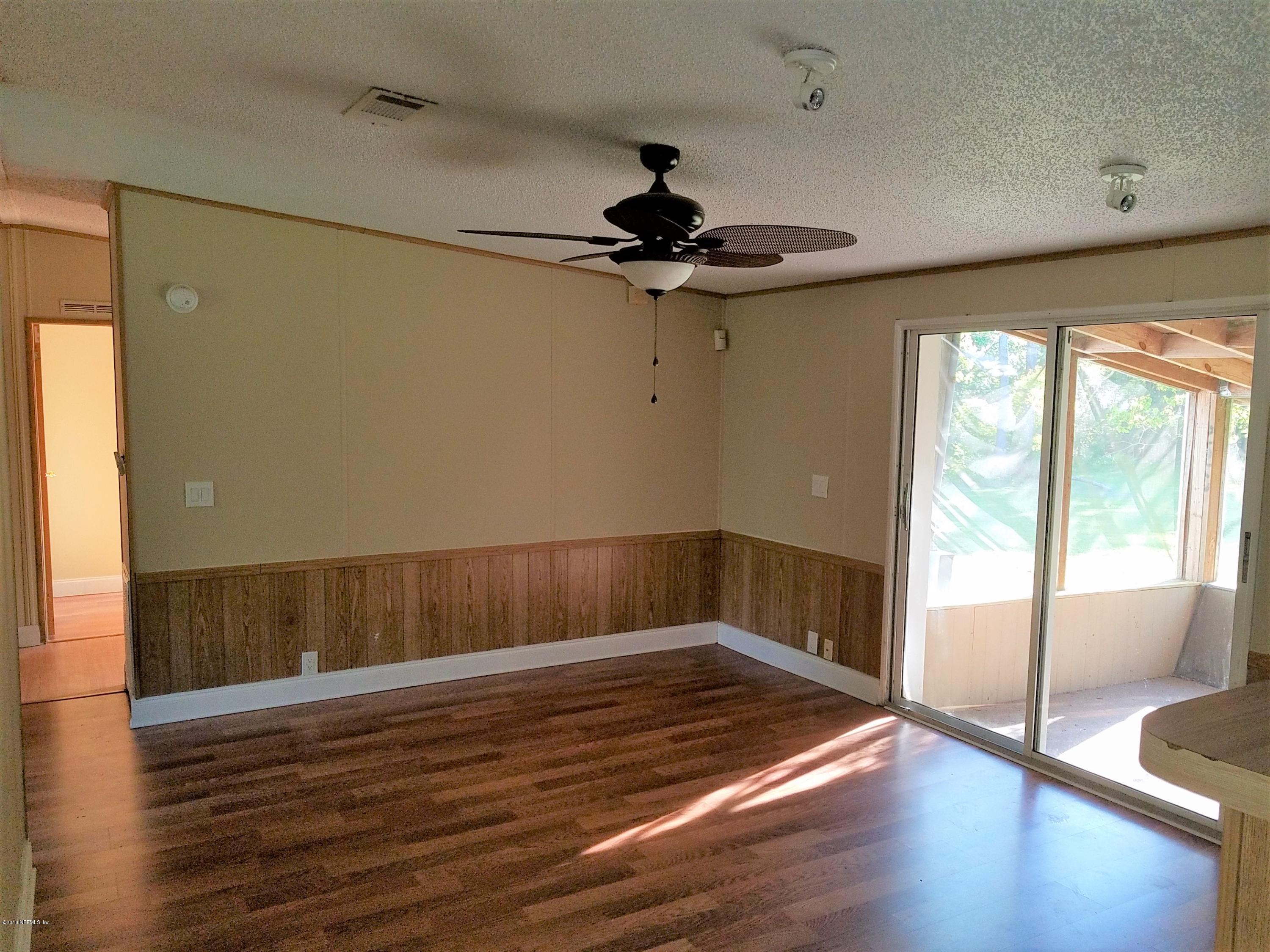 2801 Green Acres Road, Unit EXTENSION St. Augustine, FL 32084 - Photo 24 of 30 a view of a room with wooden floor and windows