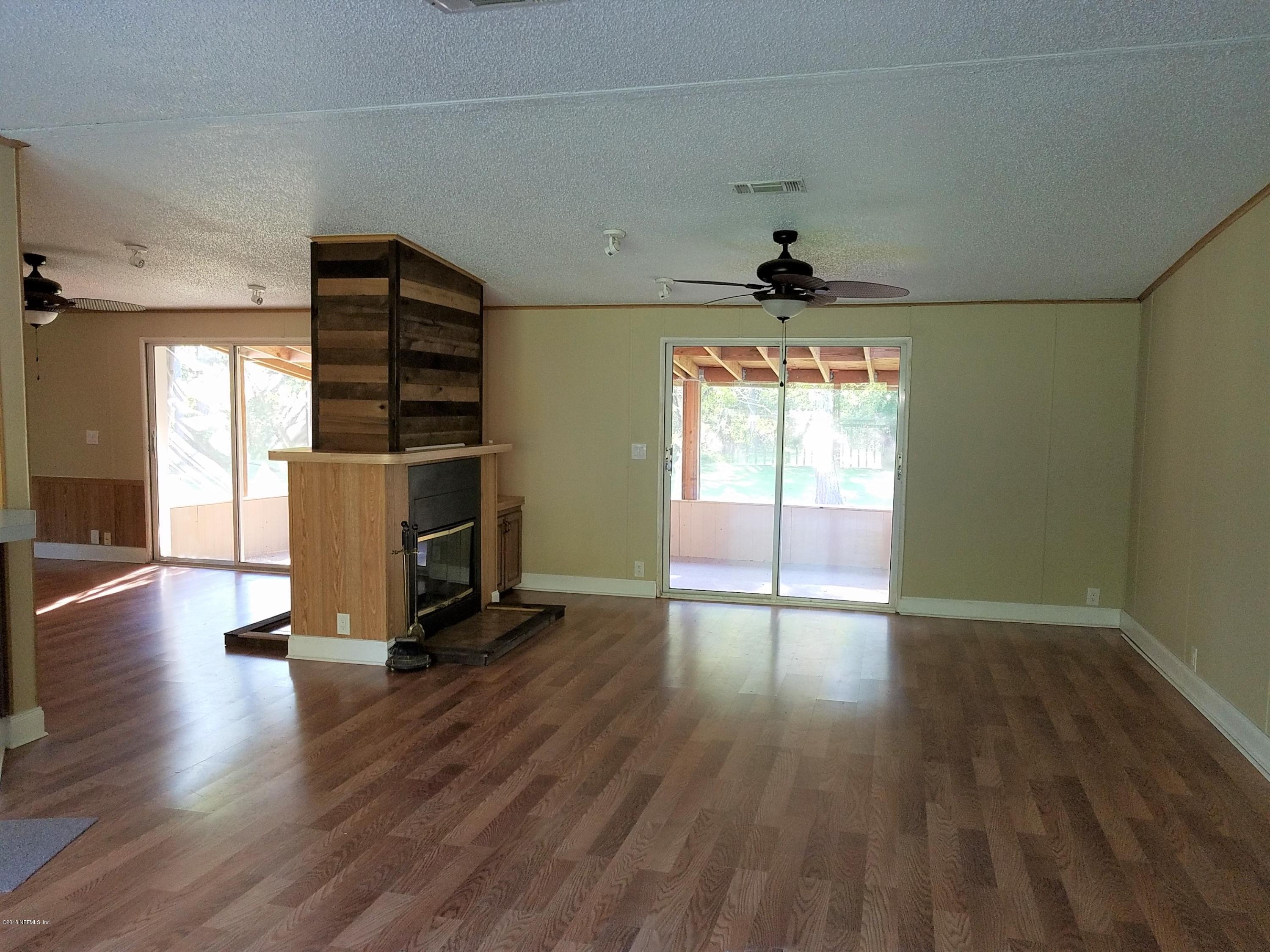 2801 Green Acres Road, Unit EXTENSION St. Augustine, FL 32084 - Photo 26 of 30 an empty room with wooden floor and windows