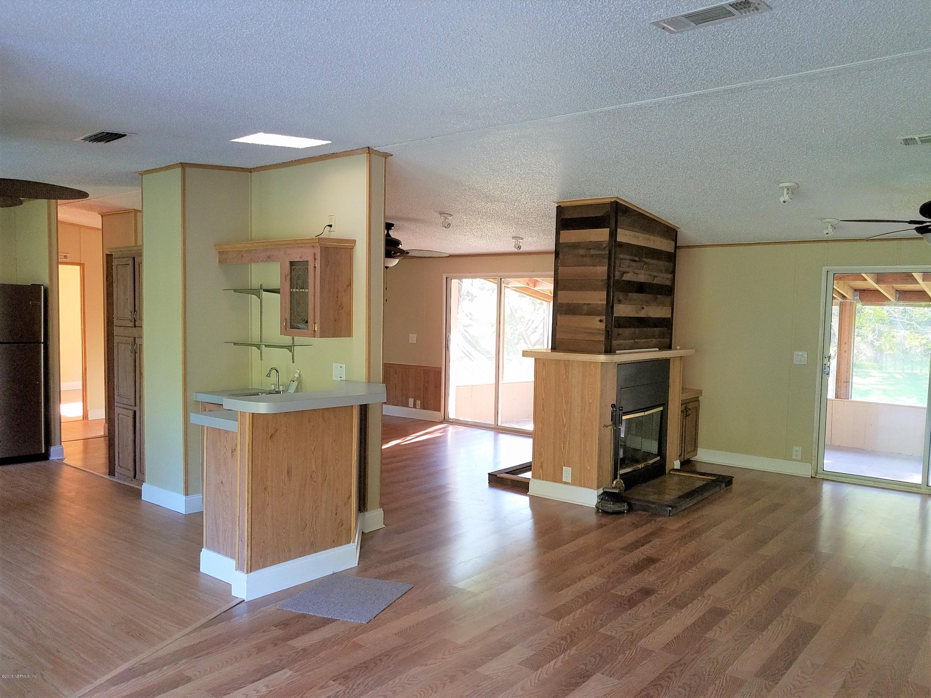2801 Green Acres Road, Unit EXTENSION St. Augustine, FL 32084 - Photo 27 of 30 a view of kitchen with stainless steel appliances cabinets and wooden floor