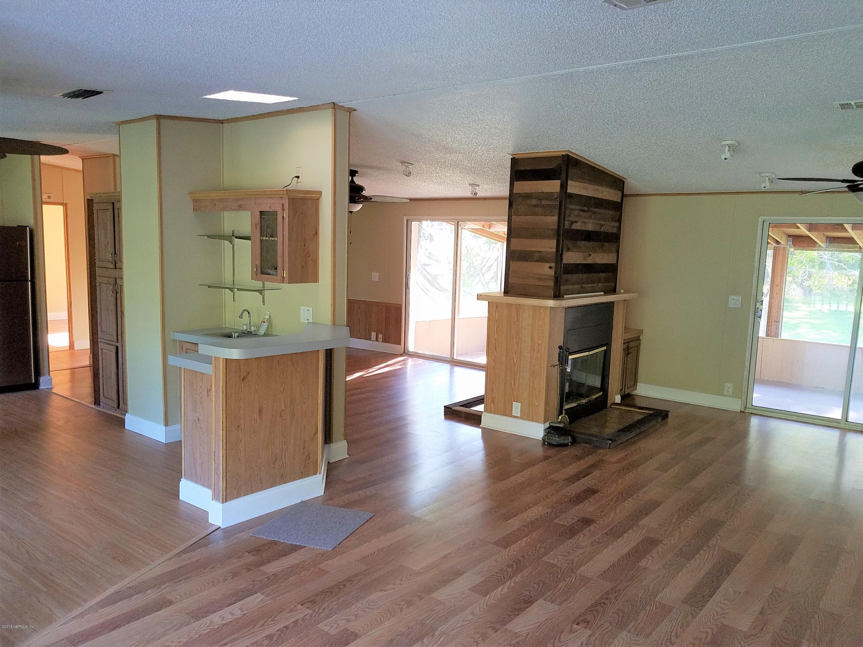 2801 Green Acres Road, Unit EXTENSION St. Augustine, FL 32084 - Photo 28 of 30 a living room with furniture and a flat screen tv