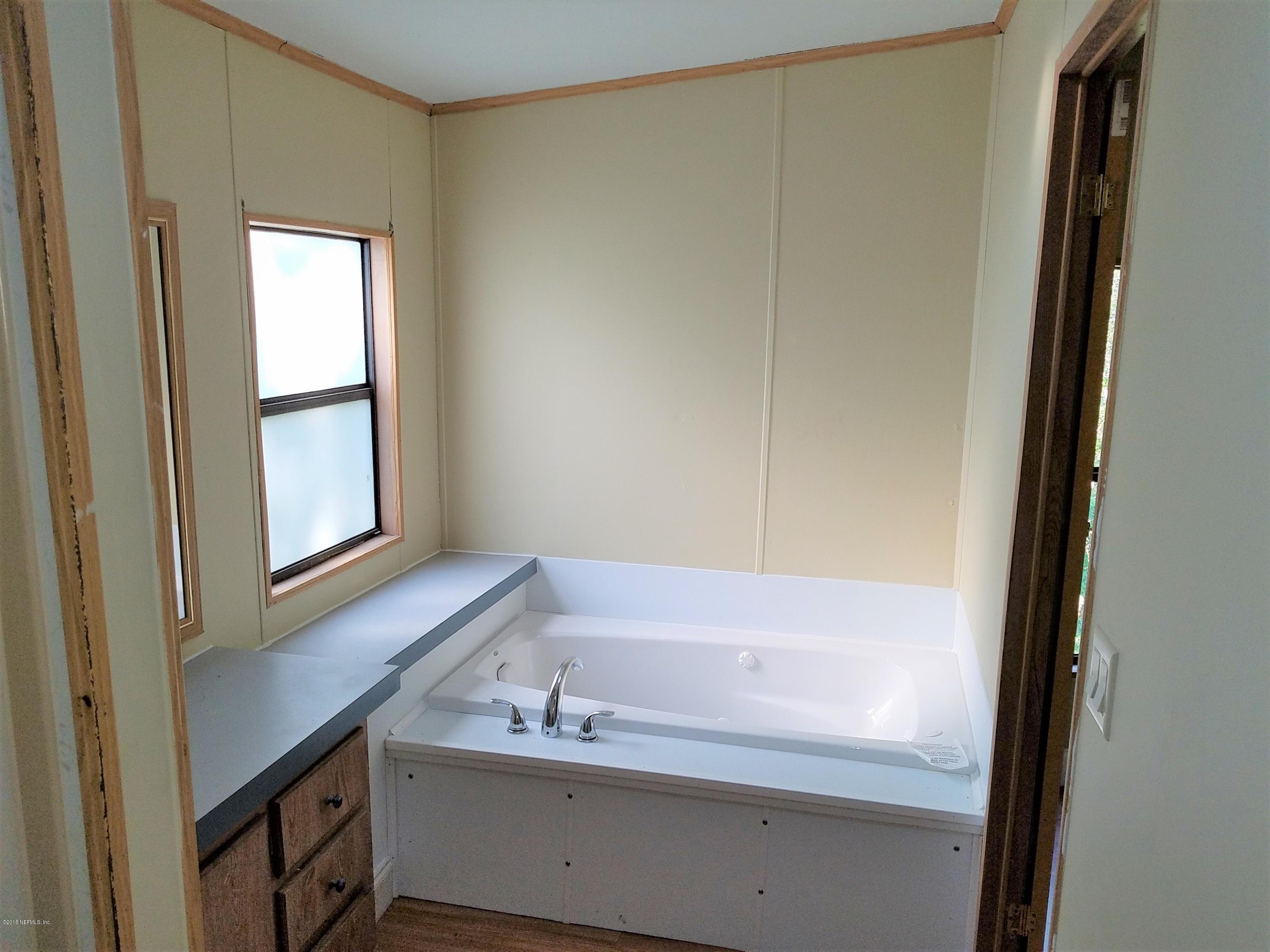 2801 Green Acres Road, Unit EXTENSION St. Augustine, FL 32084 - Photo 29 of 30 a bathroom with a bathtub and a sink