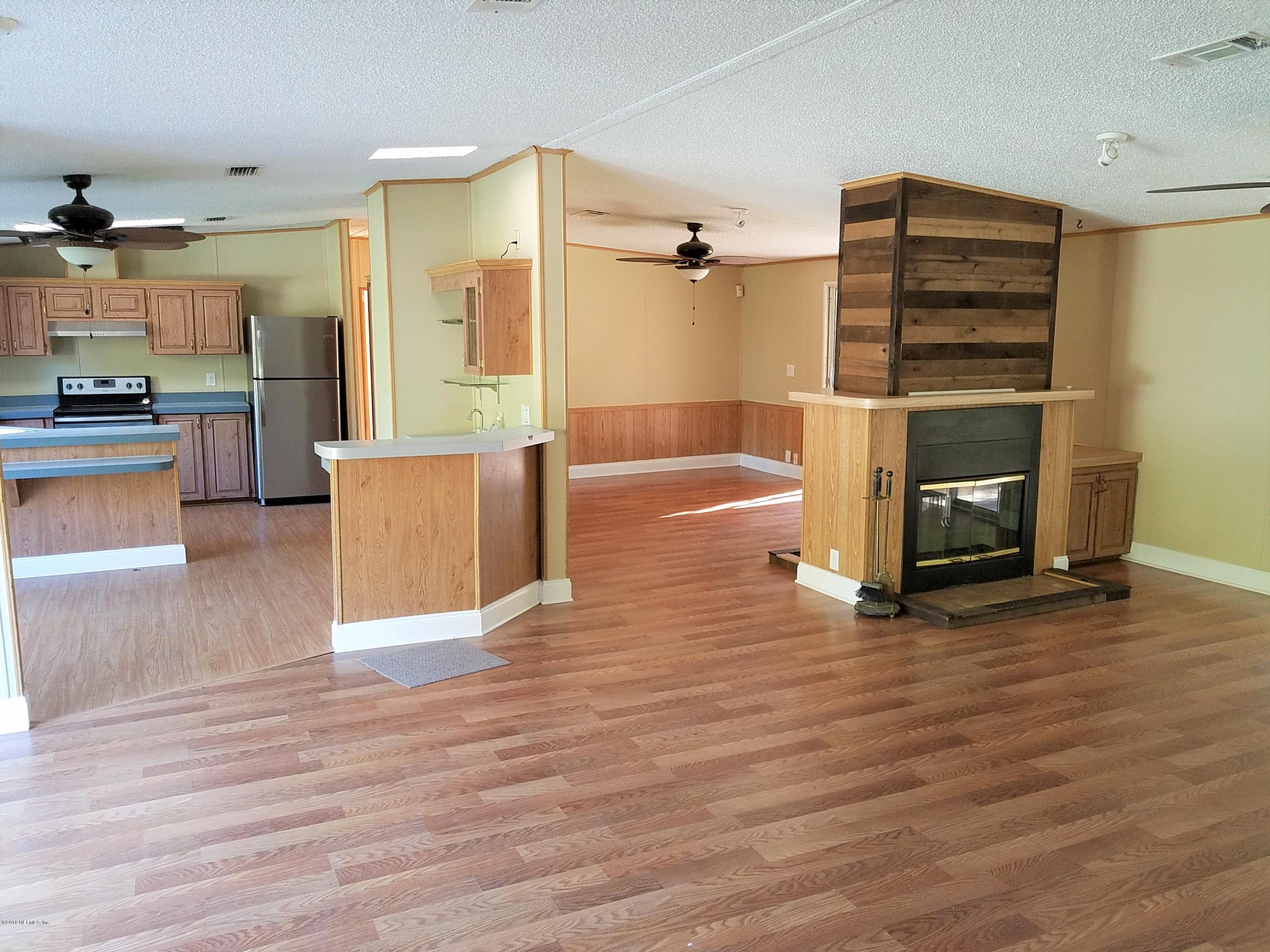 2801 Green Acres Road, Unit EXTENSION St. Augustine, FL 32084 - Photo 3 of 30 a view of a living room with furniture and a fireplace