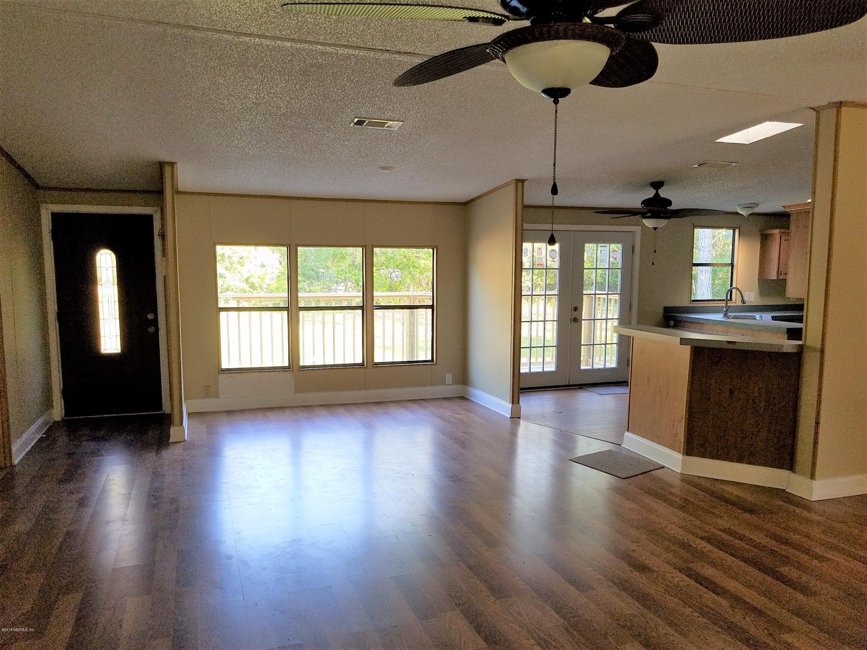 2801 Green Acres Road, Unit EXTENSION St. Augustine, FL 32084 - Photo 4 of 30 a view of an empty room with window and wooden floor