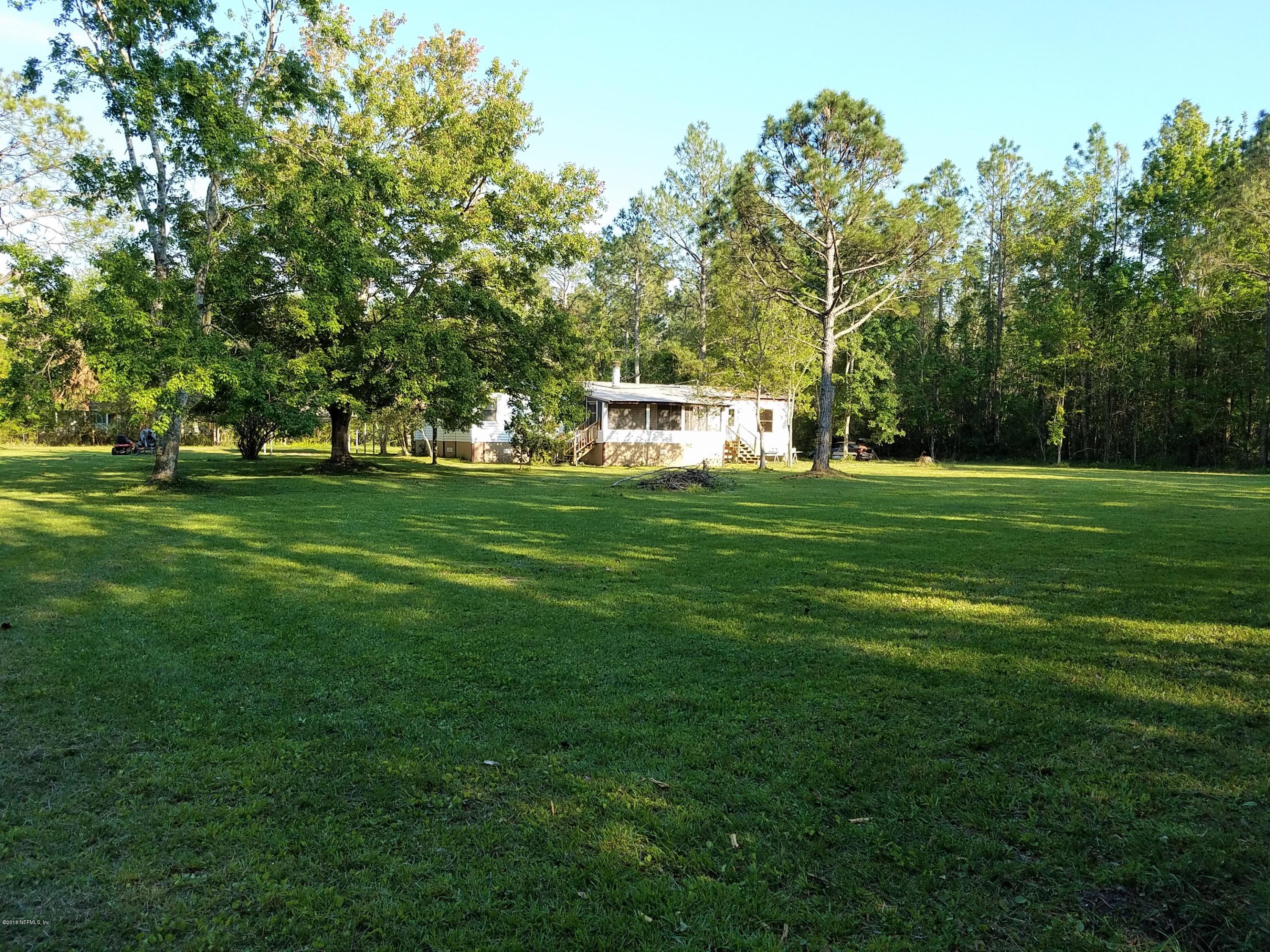 2801 Green Acres Road, Unit EXTENSION St. Augustine, FL 32084 - Photo 5 of 30 a front view of a house with a big yard