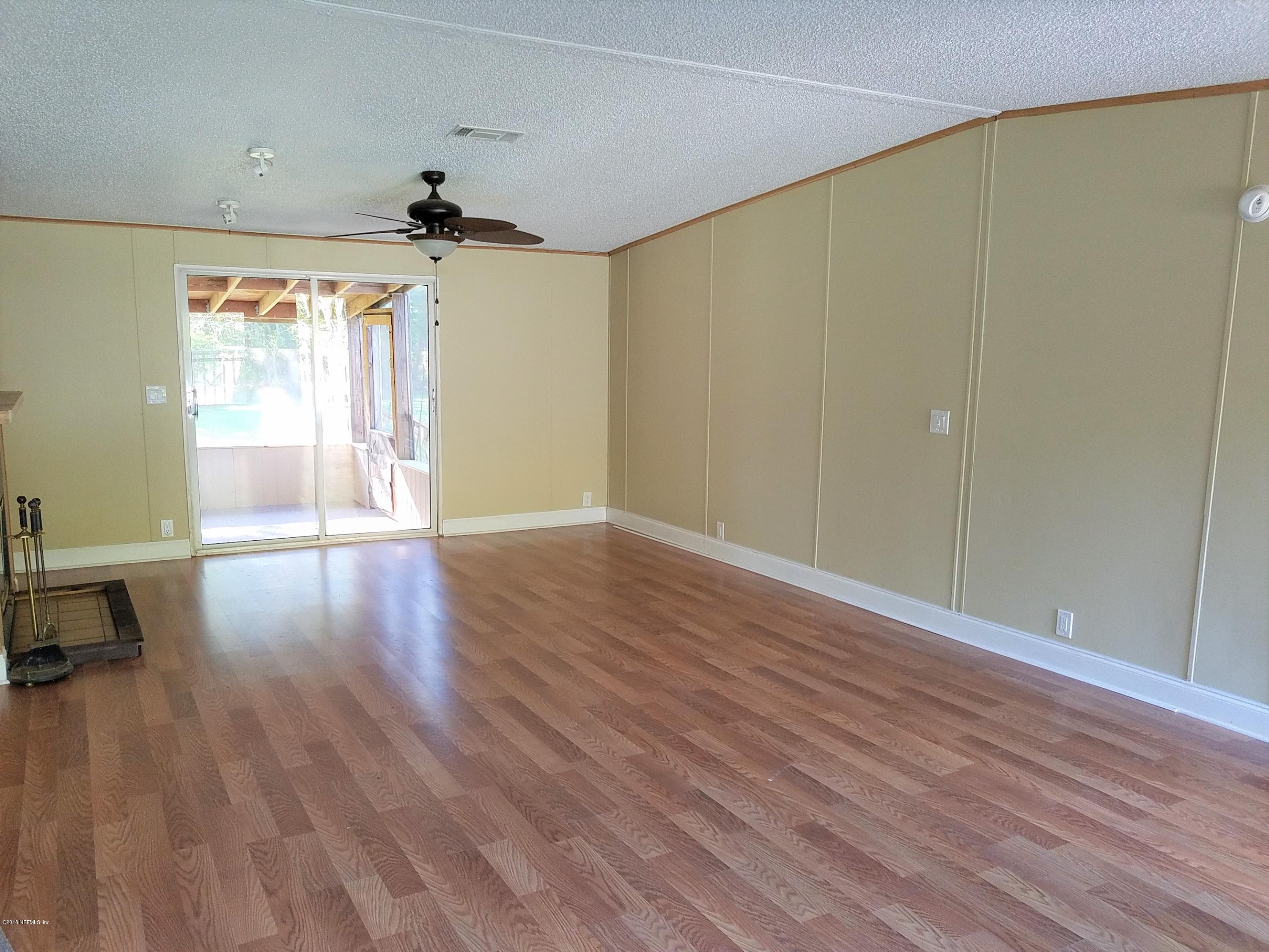 2801 Green Acres Road, Unit EXTENSION St. Augustine, FL 32084 - Photo 6 of 30 an empty room with wooden floor and windows