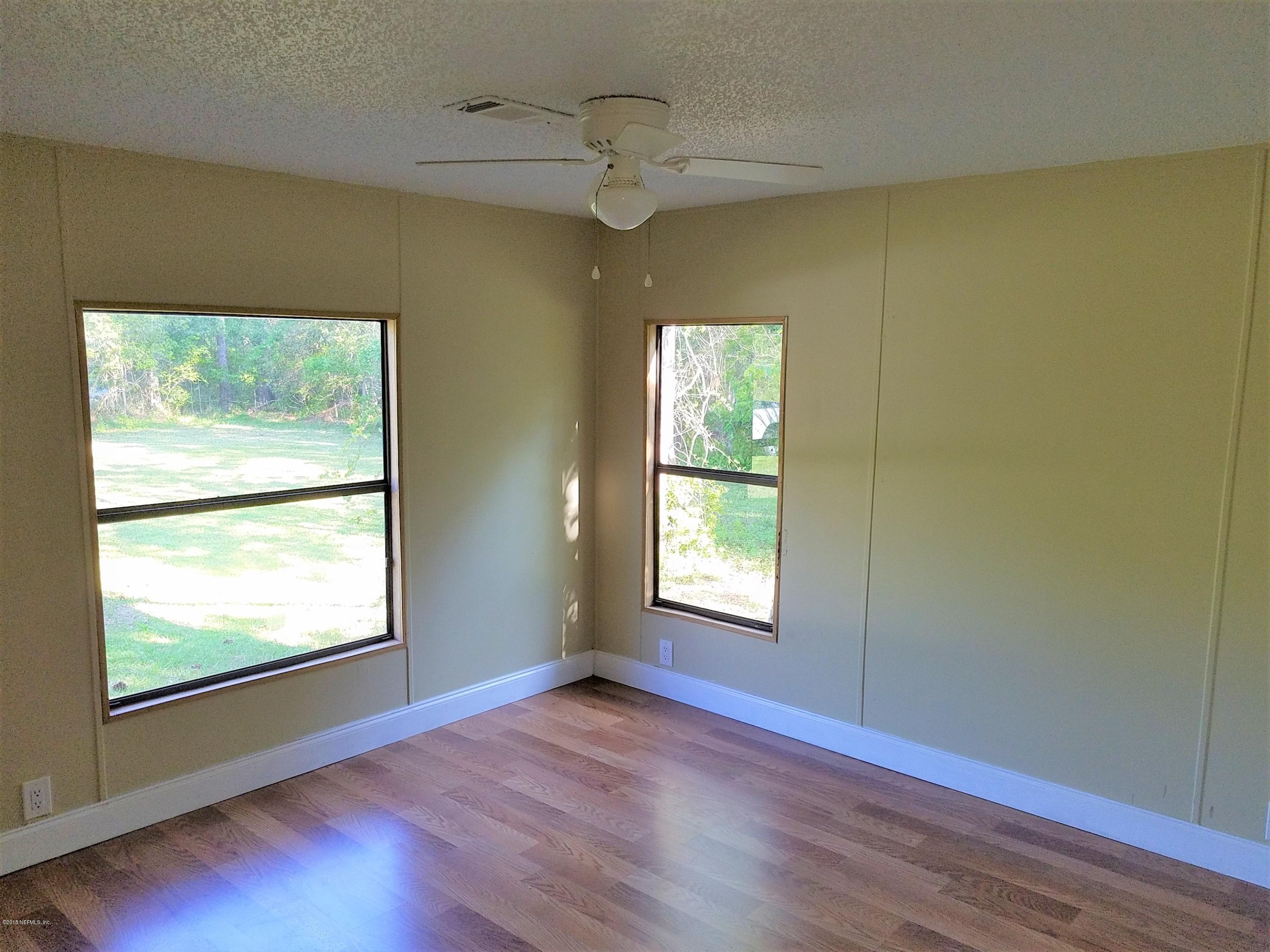 2801 Green Acres Road, Unit EXTENSION St. Augustine, FL 32084 - Photo 10 of 30 a view of an empty room with wooden floor and a window