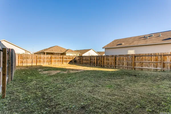 a view of an house with backyard space and balcony