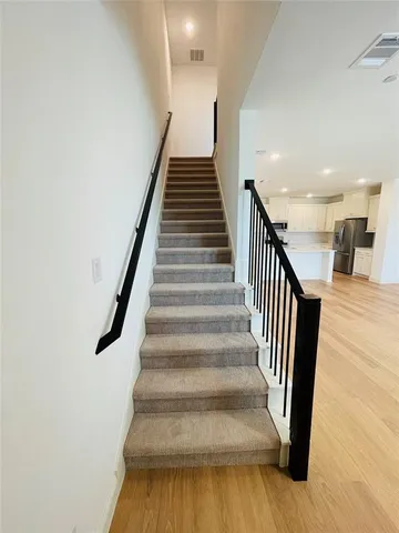 a view of entryway and hall with wooden floor
