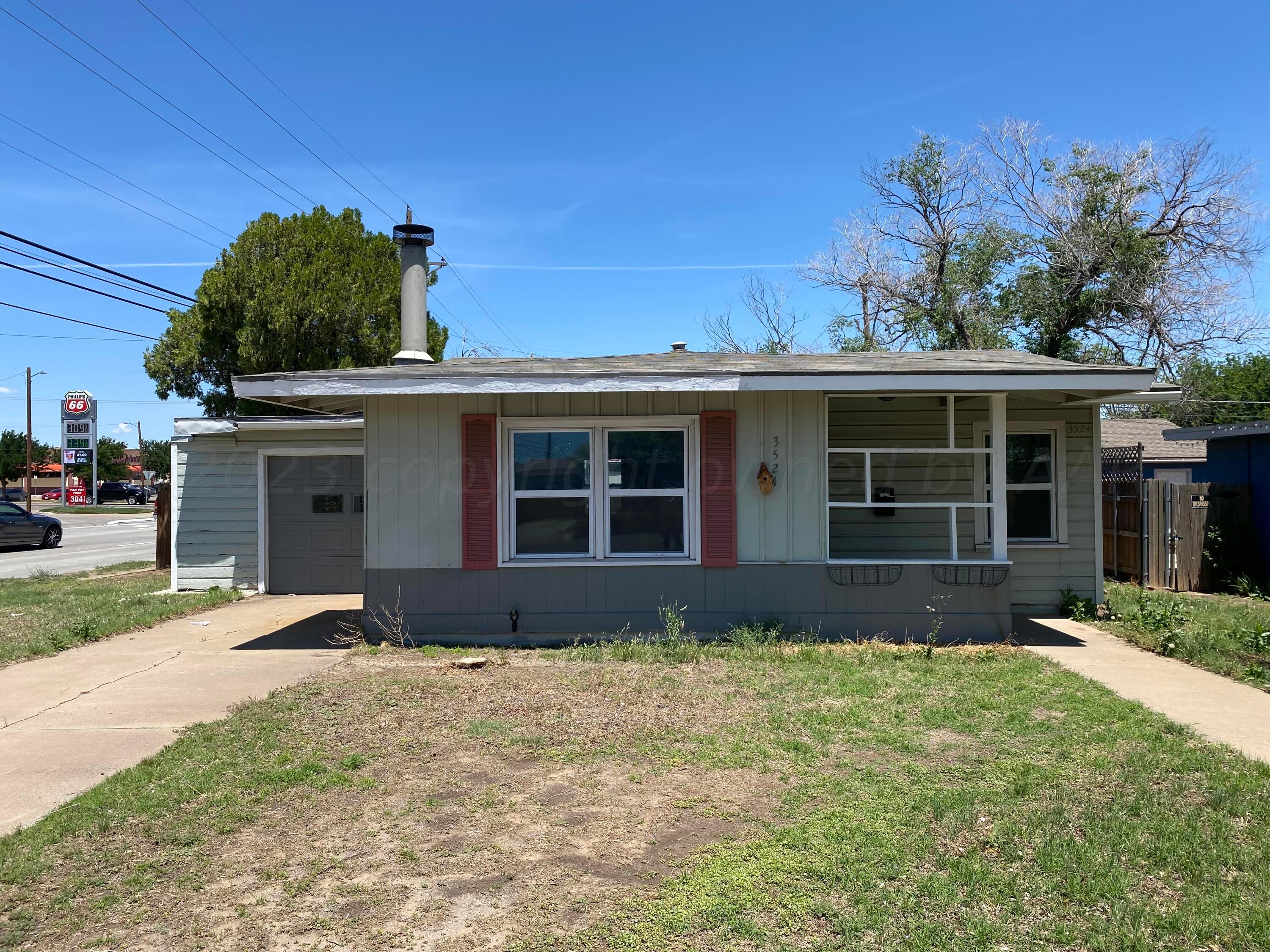 3524 Lometa Drive Amarillo, TX 79109 - Photo 1 of 7 a front view of a house with a yard and garage