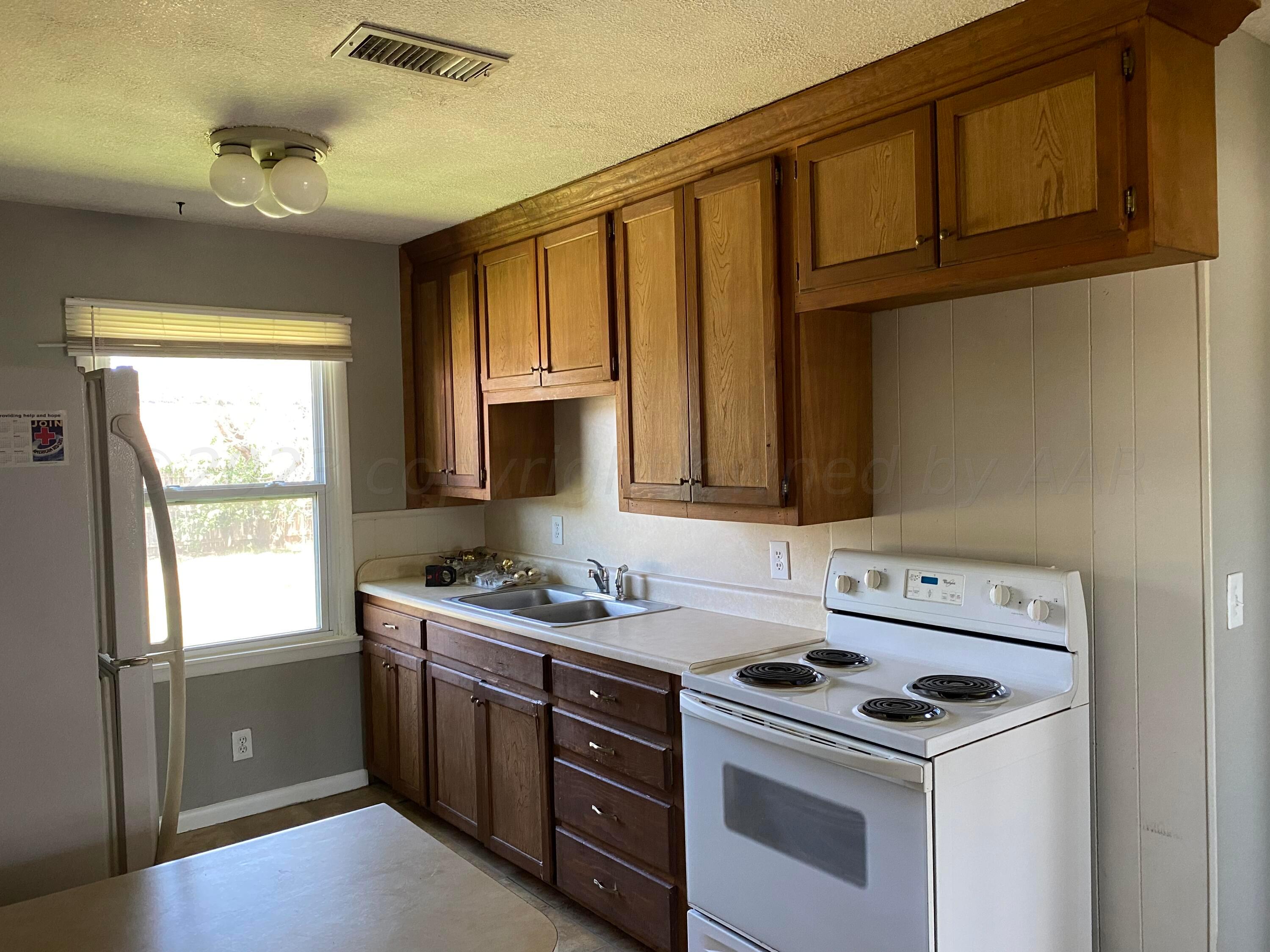 3524 Lometa Drive Amarillo, TX 79109 - Photo 3 of 7 a kitchen with a stove and a sink