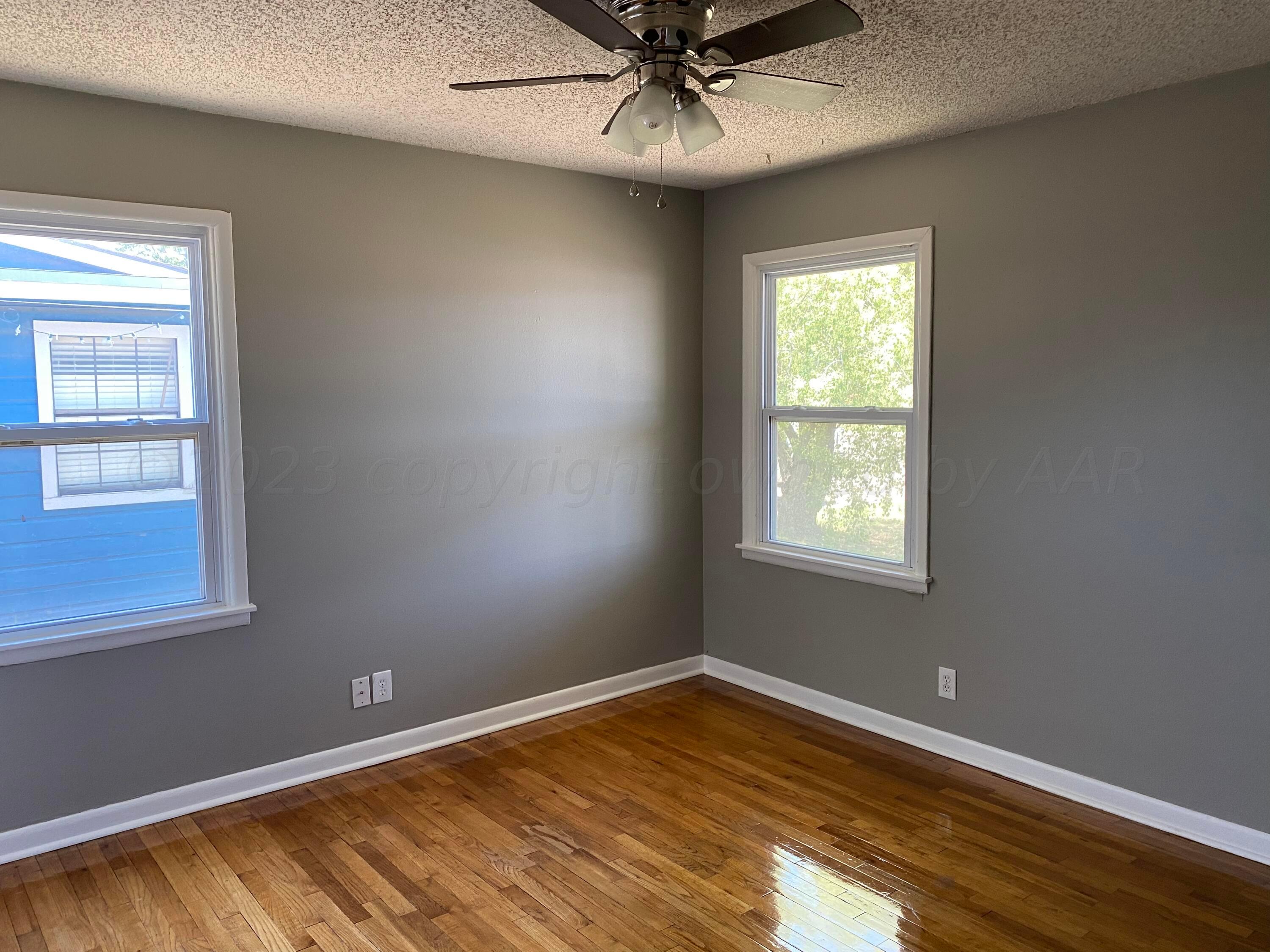 3524 Lometa Drive Amarillo, TX 79109 - Photo 5 of 7 a view of an empty room with wooden floor and a window