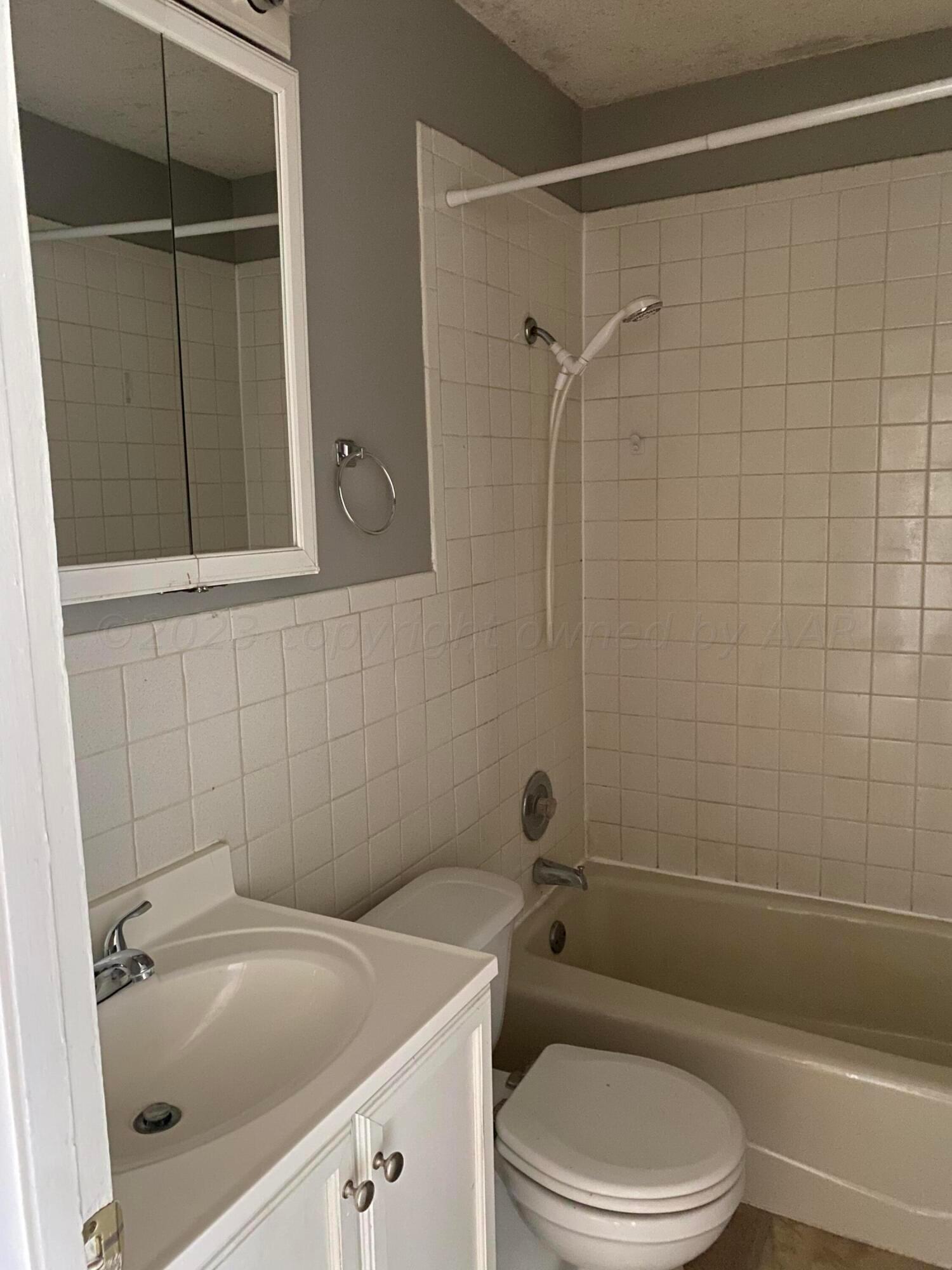 3524 Lometa Drive Amarillo, TX 79109 - Photo 6 of 7 a bathroom with a sink a toilet and shower