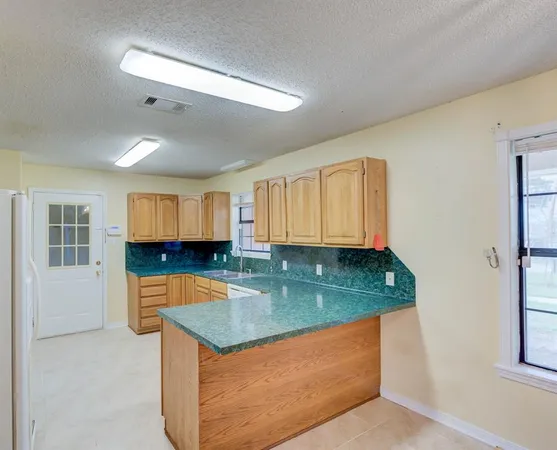 a kitchen with stainless steel appliances granite countertop a sink and a white cabinets