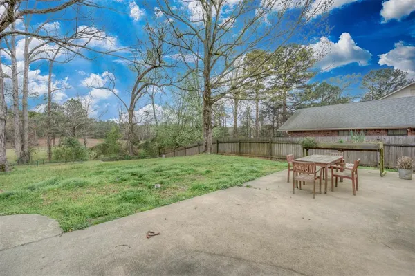 a view of a backyard with table and chairs and a fire pit