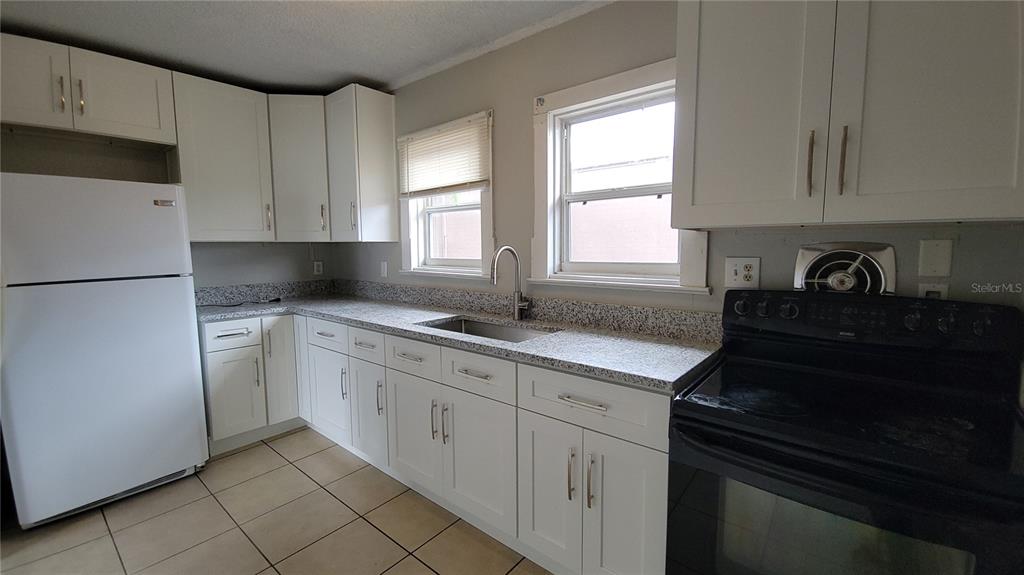 200 Old Daytona Road Deland, FL 32724 - Photo 17 of 23 a kitchen with a sink stove and cabinets