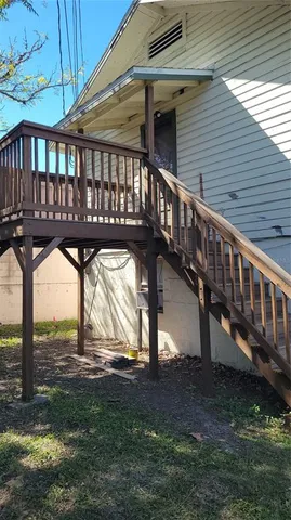 a view of house with backyard and deck