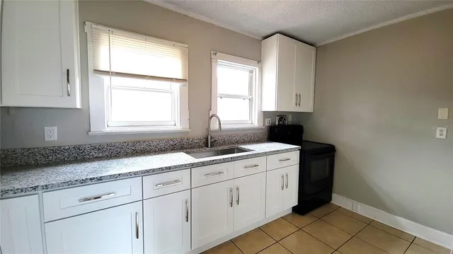 a kitchen with a sink and cabinets