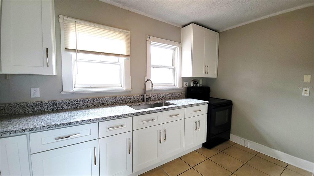 200 Old Daytona Road Deland, FL 32724 - Photo 9 of 23 a kitchen with a sink and cabinets