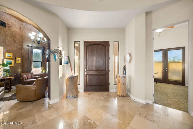 a living room with furniture kitchen view and a large window