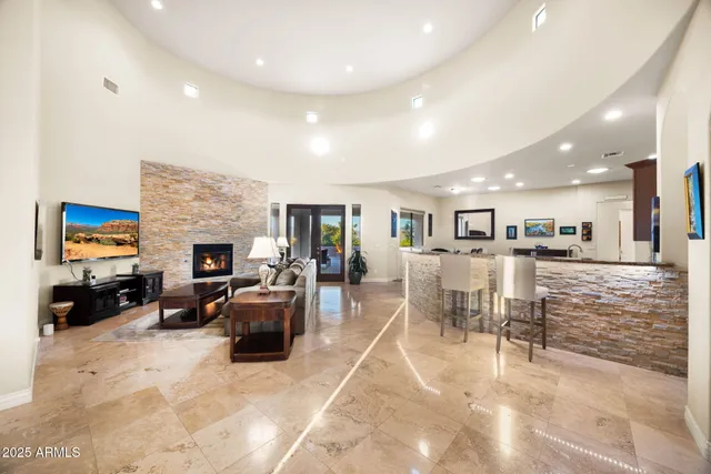 a living room with furniture large window and a fireplace