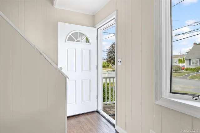 a view of front door with wooden floor