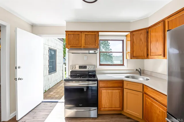 a kitchen with stainless steel appliances a stove sink and cabinets