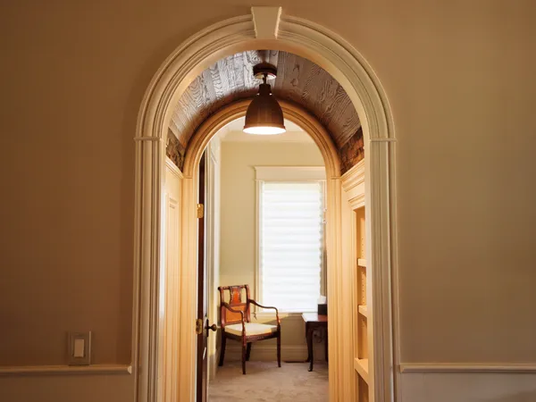 a bedroom with bed and a large window
