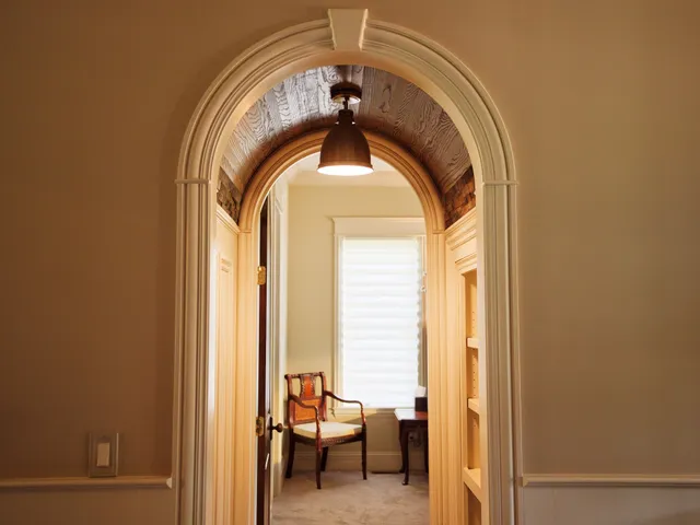 a bedroom with bed and a large window