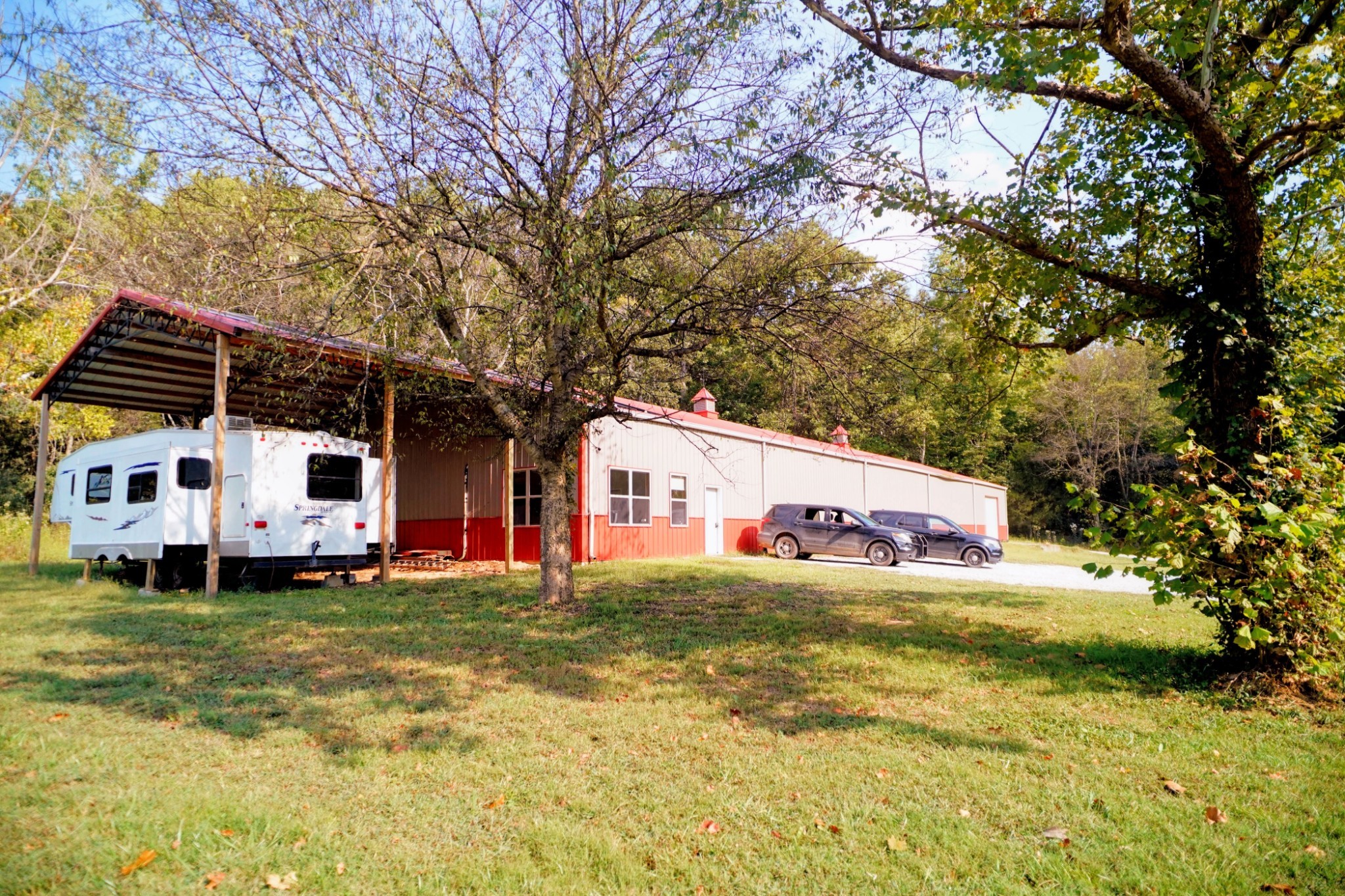 450 Lowe Branch Road Centerville, TN 37033 - Photo 97 of 100 a front view of a house with a garden and trees