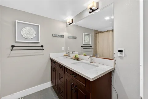 a bathroom with a sink vanity and a mirror