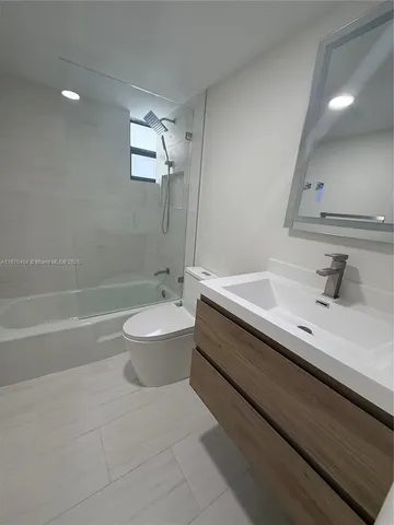 a bathroom with a sink a toilet and a bathtub