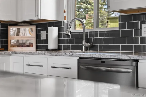 a kitchen with stainless steel appliances granite countertop a stove and cabinets