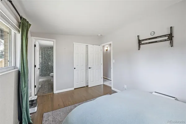 a bathroom with a sink a toilet a shower and a window