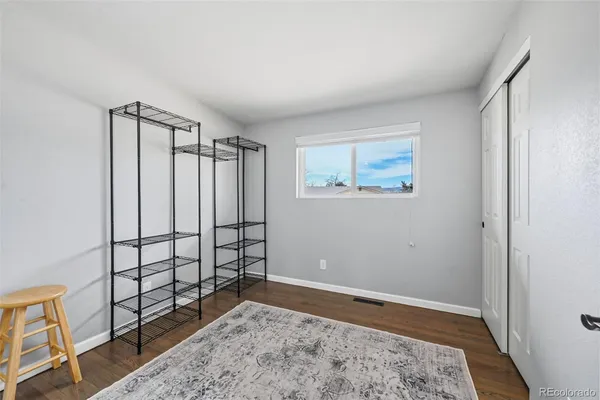 a living room with furniture a window and a wooden floor