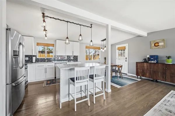 a view of a dining room with furniture and wooden floor