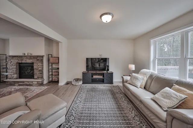 a living room with furniture and a fireplace