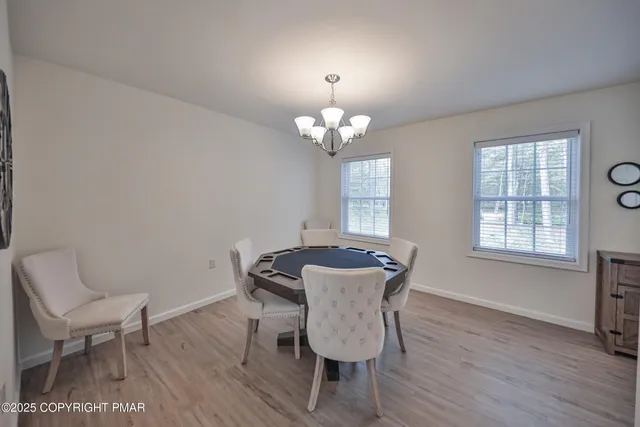 a view of a dining room with furniture and chandelier